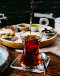 side-view-tea-pouring-into-armudu-glass